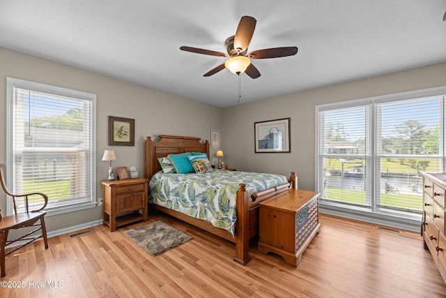 6008 Cassowary Ln, New Bern, NC 28560 - bedroom with light wood-style flooring, multiple windows, baseboards, and a ceiling fan