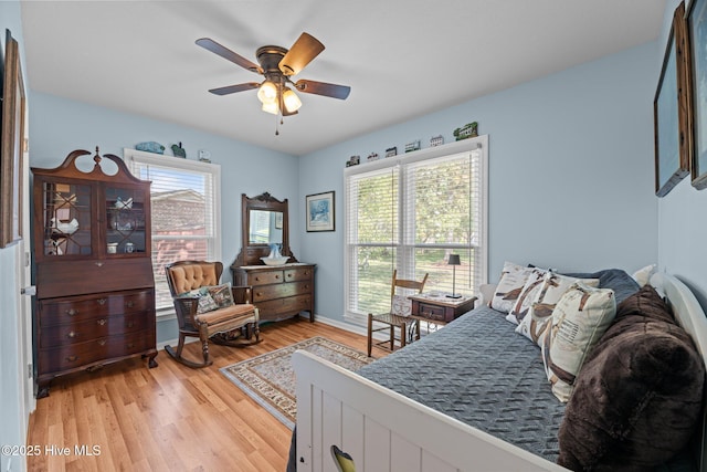 6008 Cassowary Ln, New Bern, NC 28560 - bedroom with light wood finished floors, ceiling fan, and baseboards