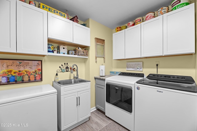 6008 Cassowary Ln, New Bern, NC 28560 - laundry room with separate washer and dryer, light wood finished floors, and cabinet space