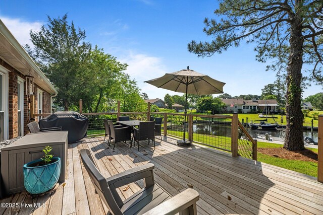 6008 Cassowary Ln, New Bern, NC 28560 - deck featuring a water view, outdoor dining space, and grilling area