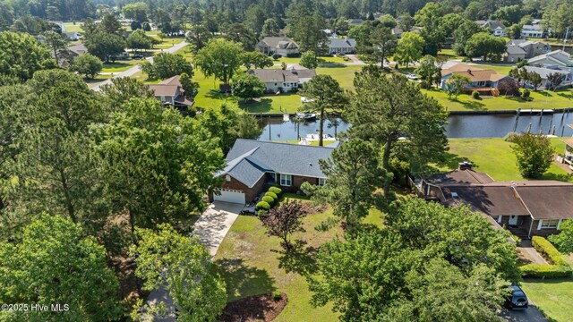 6008 Cassowary Ln, New Bern, NC 28560 - aerial perspective of suburban area featuring a large body of water and a tree filled landscape
