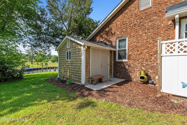 6008 Cassowary Ln, New Bern, NC 28560 - view of property exterior featuring a lawn, a water view, and brick siding