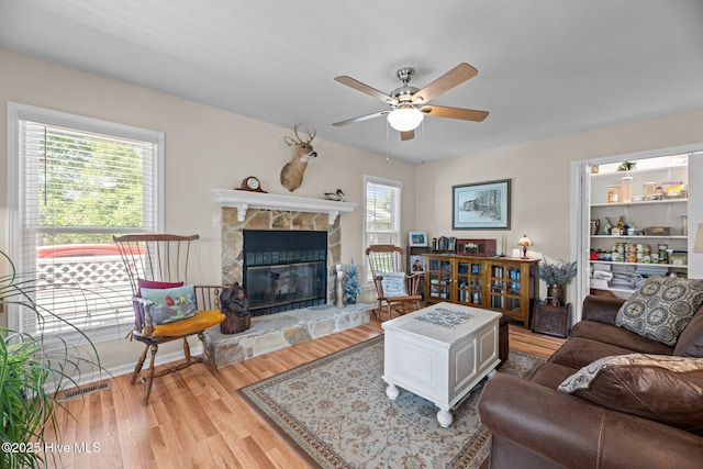 6008 Cassowary Ln, New Bern, NC 28560 - living room with a ceiling fan, wood finished floors, and a stone fireplace