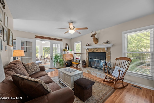 6008 Cassowary Ln, New Bern, NC 28560 - living room featuring a ceiling fan, light wood-style floors, a fireplace, and baseboards
