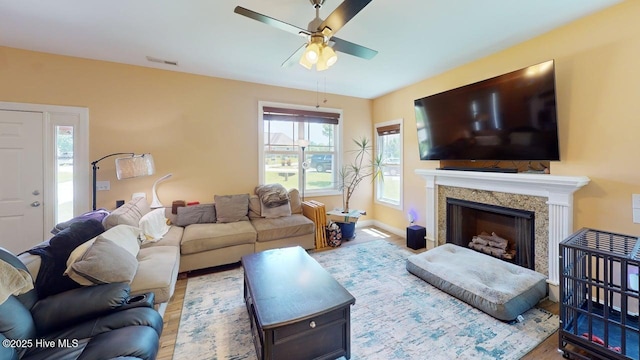 44 Nassau Ct, Clayton, NC 27520 - living room featuring a ceiling fan, wood finished floors, a fireplace, and baseboards