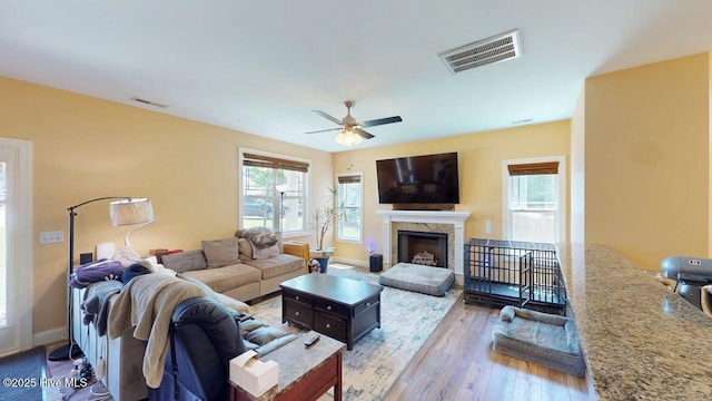44 Nassau Ct, Clayton, NC 27520 - living room with hardwood / wood-style flooring, a ceiling fan, a fireplace, and baseboards