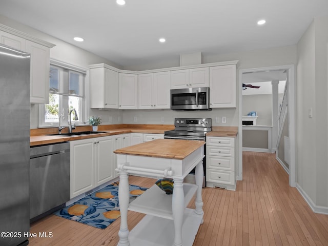 120 Buds Ln, Cedar Point, NC 28584 - kitchen with appliances with stainless steel finishes, a sink, wooden counters, white cabinets, and recessed lighting