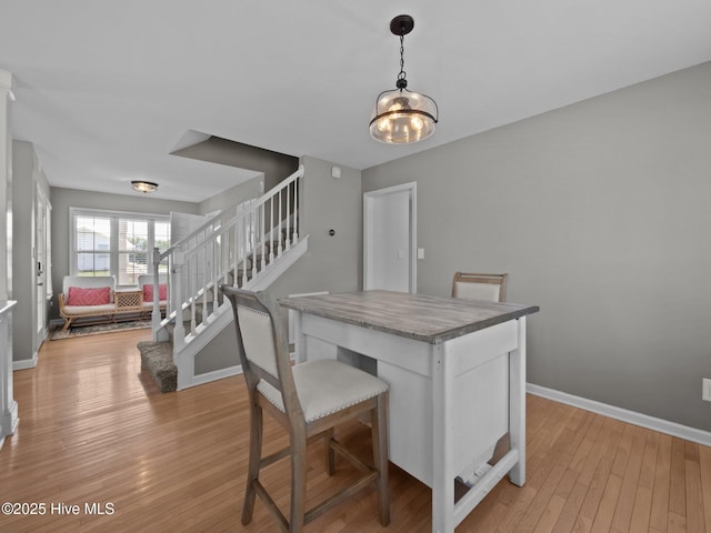 120 Buds Ln, Cedar Point, NC 28584 - dining room with stairway, light wood finished floors, and baseboards