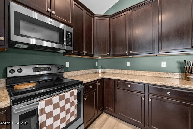 211 Bill Canady Rd, Sneads Ferry, NC 28460 - kitchen featuring stainless steel appliances, dark brown cabinets, light stone counters, and light wood-style flooring