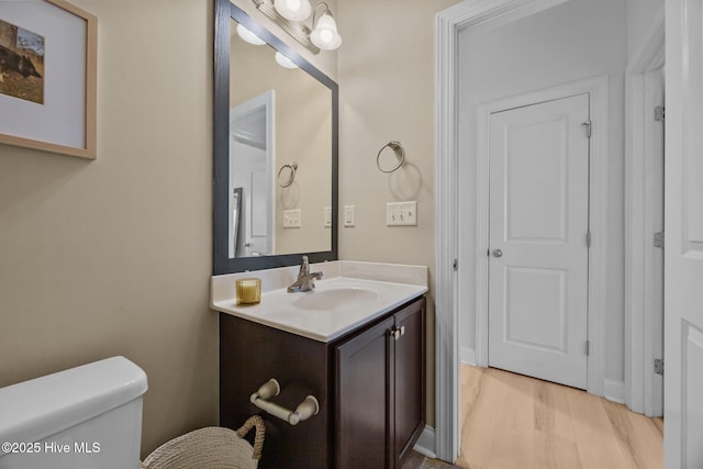 211 Bill Canady Rd, Sneads Ferry, NC 28460 - half bathroom featuring vanity, toilet, and wood finished floors