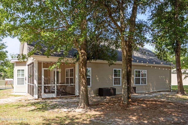 211 Bill Canady Rd, Sneads Ferry, NC 28460 - back of property with a sunroom, a shingled roof, and cooling unit