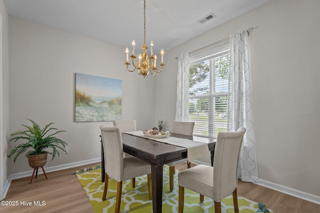 1424 Elgin St, Wilmington, NC 28409 - dining area with a chandelier and light wood-style flooring