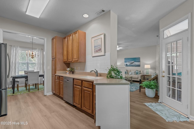 1424 Elgin St, Wilmington, NC 28409 - kitchen featuring stainless steel appliances, a chandelier, light wood-style flooring, and light countertops