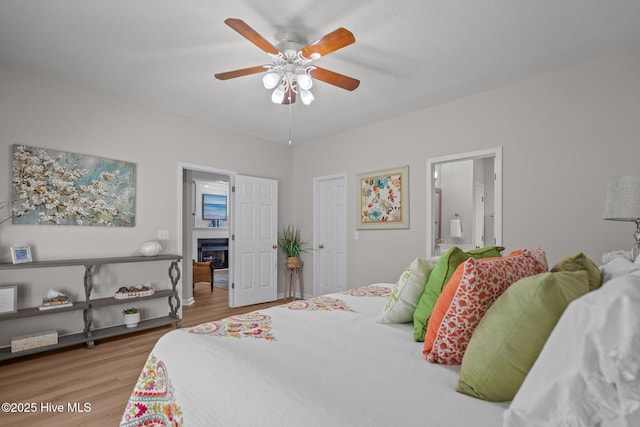1424 Elgin St, Wilmington, NC 28409 - bedroom featuring light wood-style flooring, ensuite bathroom, a ceiling fan, and a fireplace
