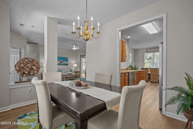 1424 Elgin St, Wilmington, NC 28409 - dining space with light wood-type flooring, a ceiling fan, and a chandelier
