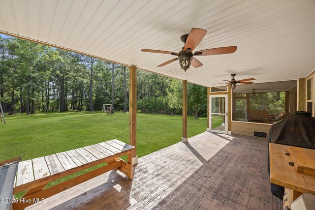 285 Mimosa Dr, Sneads Ferry, NC 28460 - view of patio with ceiling fan, view of wooded area, and a deck