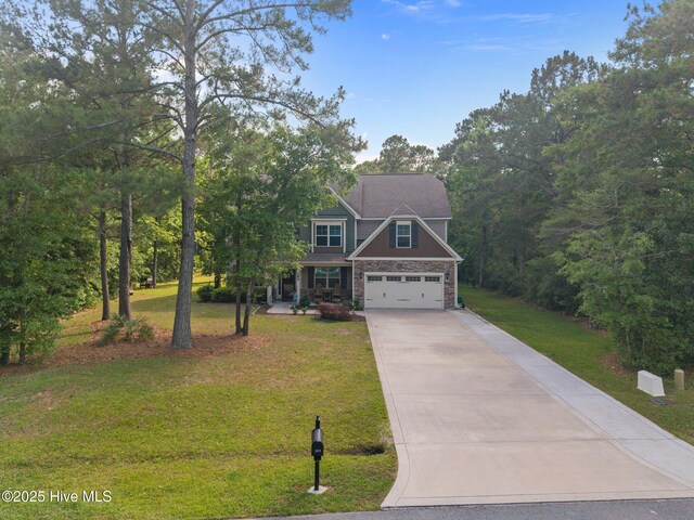 285 Mimosa Dr, Sneads Ferry, NC 28460 - craftsman-style home featuring concrete driveway, a front lawn, covered porch, and a garage