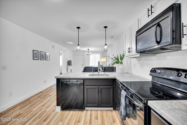 522 S Kerr Ave Unit 66, Wilmington, NC 28403 - kitchen featuring black appliances, a sink, a peninsula, backsplash, and light wood-type flooring