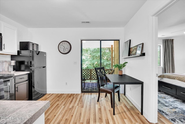 522 S Kerr Ave Unit 66, Wilmington, NC 28403 - kitchen featuring freestanding refrigerator, baseboards, light wood-style flooring, and light countertops