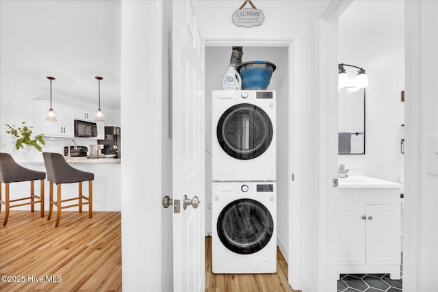 522 S Kerr Ave Unit 66, Wilmington, NC 28403 - washroom featuring stacked washer / dryer and light wood-style floors