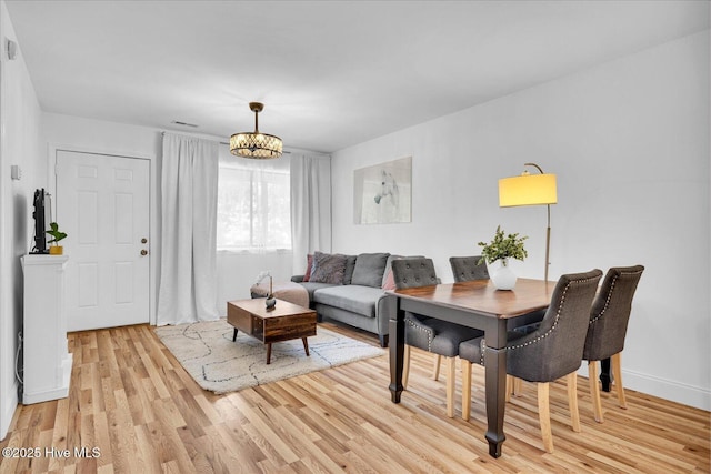 522 S Kerr Ave Unit 66, Wilmington, NC 28403 - living room featuring light wood finished floors, a chandelier, and baseboards
