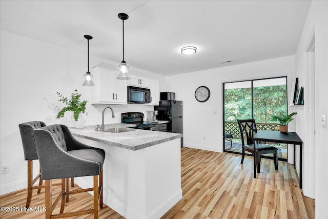 522 S Kerr Ave Unit 66, Wilmington, NC 28403 - kitchen featuring black appliances, a sink, baseboards, a peninsula, and light countertops