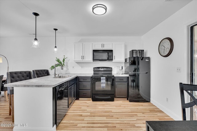 522 S Kerr Ave Unit 66, Wilmington, NC 28403 - kitchen featuring black appliances, a sink, a peninsula, and light wood-style floors