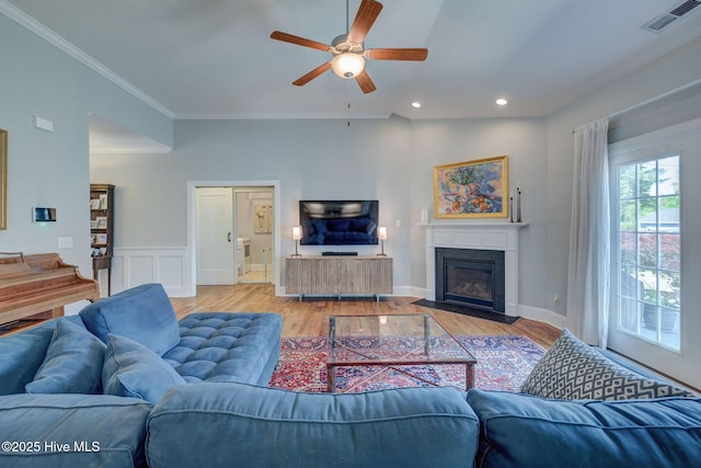 6122 Chancellorsville Dr, Wilmington, NC 28409 - living room featuring a ceiling fan, light wood-style floors, a fireplace with flush hearth, recessed lighting, and ornamental molding