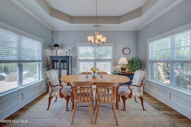 6122 Chancellorsville Dr, Wilmington, NC 28409 - dining room featuring a raised ceiling, a chandelier, and wood finished floors