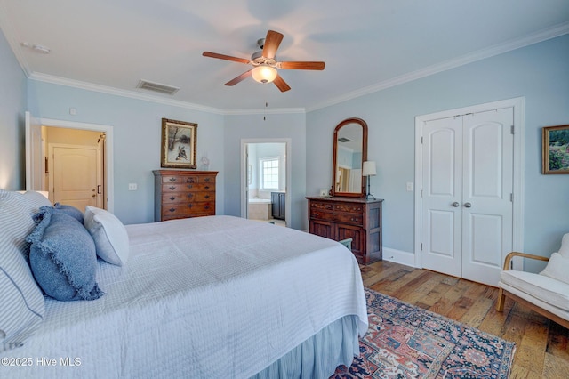 6122 Chancellorsville Dr, Wilmington, NC 28409 - bedroom with wood finished floors, a closet, ornamental molding, a ceiling fan, and baseboards