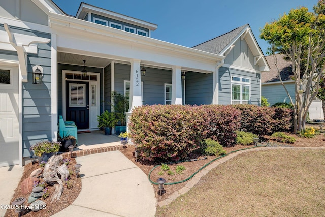 6122 Chancellorsville Dr, Wilmington, NC 28409 - view of exterior entry featuring a porch and board and batten siding
