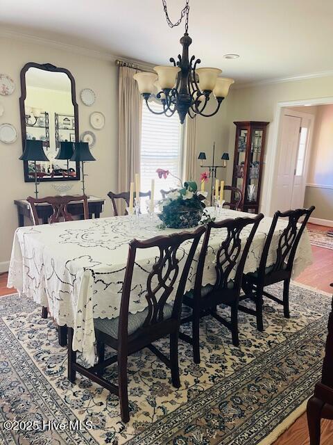 2008 Hardee Rd, Kinston, NC 28504 - dining area featuring a chandelier, wood finished floors, ornamental molding, and baseboards