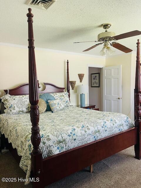 2008 Hardee Rd, Kinston, NC 28504 - bedroom with carpet floors, crown molding, a textured ceiling, and a ceiling fan