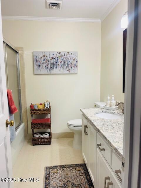 2008 Hardee Rd, Kinston, NC 28504 - bathroom featuring vanity, toilet, crown molding, and bath / shower combo with glass door