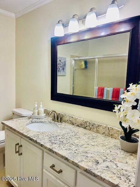 2008 Hardee Rd, Kinston, NC 28504 - full bathroom featuring toilet, vanity, a stall shower, and ornamental molding