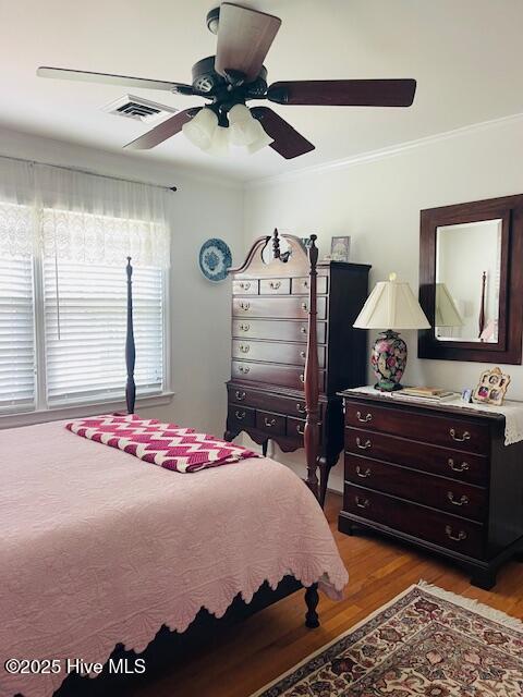 2008 Hardee Rd, Kinston, NC 28504 - bedroom featuring wood finished floors, crown molding, and a ceiling fan