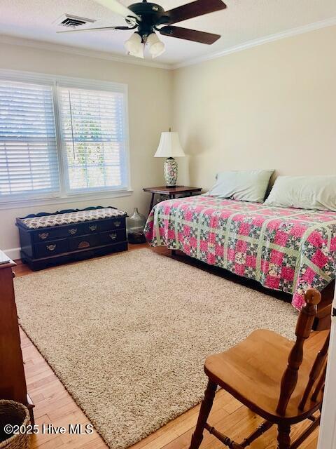 2008 Hardee Rd, Kinston, NC 28504 - bedroom featuring ornamental molding, light wood-style flooring, and a ceiling fan