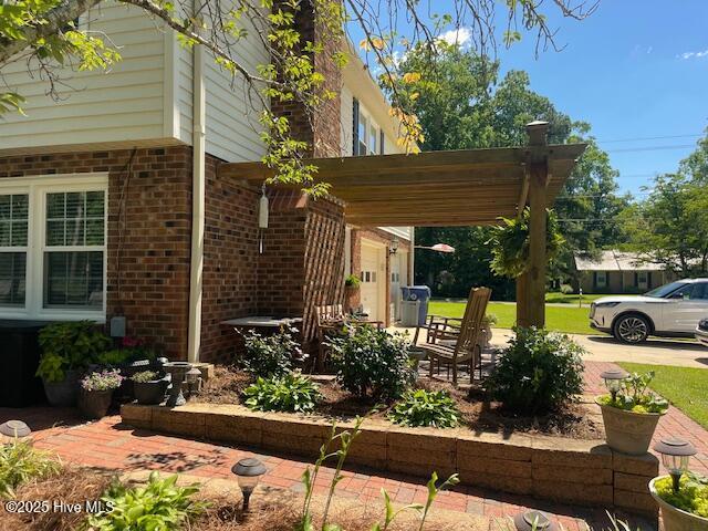 2008 Hardee Rd, Kinston, NC 28504 - view of property exterior with brick siding and a pergola