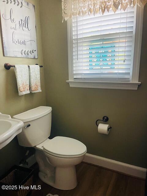 2008 Hardee Rd, Kinston, NC 28504 - bathroom featuring toilet, wood finished floors, and baseboards