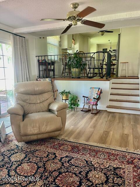 2008 Hardee Rd, Kinston, NC 28504 - living area with ceiling fan, wood finished floors, a textured ceiling, and stairs