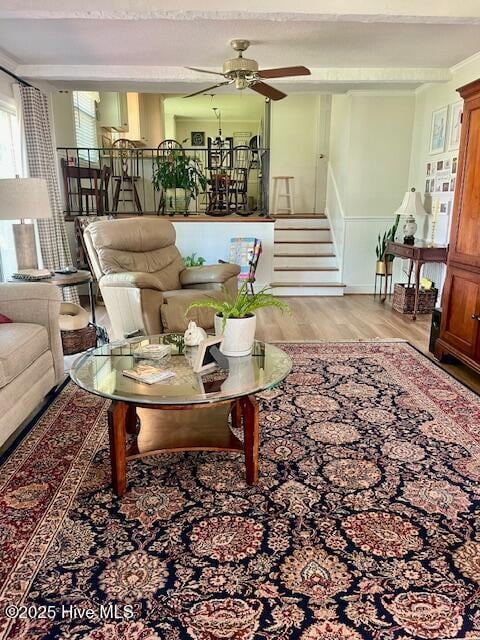 2008 Hardee Rd, Kinston, NC 28504 - living area featuring wood finished floors, stairs, a ceiling fan, and a wainscoted wall