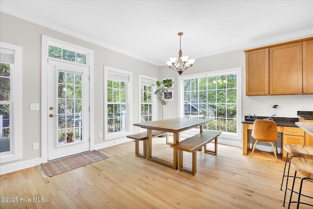 10196 Flint Ct SE, Leland, NC 28451 - dining space with light wood-style flooring, ornamental molding, healthy amount of natural light, a chandelier, and baseboards
