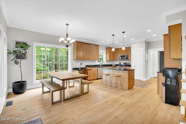 10196 Flint Ct SE, Leland, NC 28451 - dining room featuring light wood-type flooring, a chandelier, recessed lighting, crown molding, and baseboards