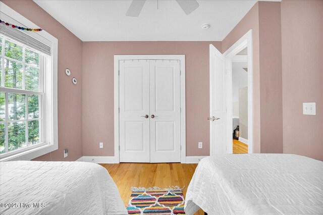 10196 Flint Ct SE, Leland, NC 28451 - bedroom featuring multiple windows, light wood finished floors, baseboards, and a closet