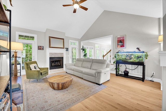 10196 Flint Ct SE, Leland, NC 28451 - living room with high vaulted ceiling, a fireplace, ceiling fan, wood finished floors, and baseboards