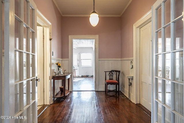entryway featuring wainscoting, wood-type flooring, french doors, and ornamental molding