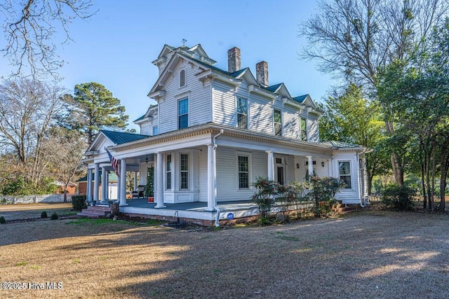 view of front facade featuring a porch and a chimney