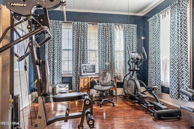 exercise area featuring crown molding