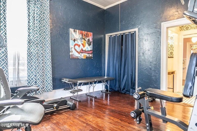 misc room with a textured wall and hardwood / wood-style floors
