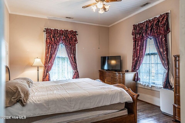 bedroom with wood finished floors, multiple windows, ornamental molding, ceiling fan, and baseboards